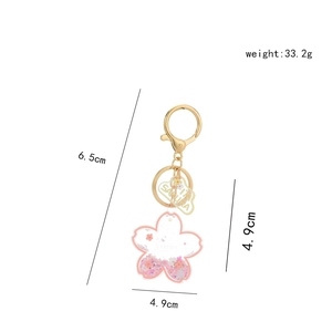Pink sakura floating liquid keychain in cherry blossom shape with gold alloy hook