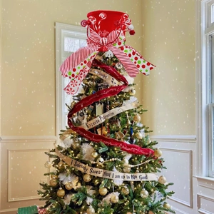 Red Christmas tree topper bow with festive candy patterns and lollipop center decoration