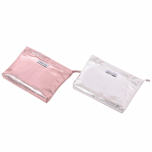 Detail of pink and silver metallic PU leather makeup bags with zipper closure and texture