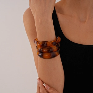 Three-piece stackable amber acrylic bangles with irregular tortoise shell pattern