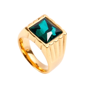 Detail of gold titanium steel ring featuring a square emerald gemstone and engraved sides
