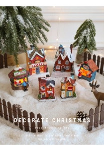 Miniature Christmas resin village shops with faux snow, pine trees and deer figures