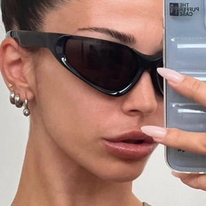 Y2K millennium style black wrap sunglasses with a sleek aerodynamic cat-eye design