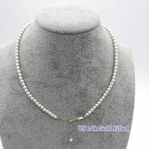 Classic white pearl necklace with 14k gold filled adjustable chain on jewelry bust