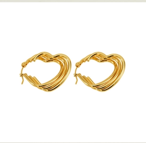 Close-up of golden heart earrings featuring triple-layered twisted wire design in polished finish