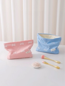 Beauty case rosa e blu con ricami a fiocco e etichetta tessuta H & R BAG sulla borsa