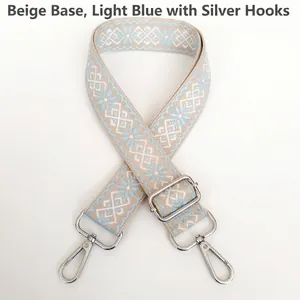Close-up of adjustable beige and light blue geometric jacquard strap with silver hooks