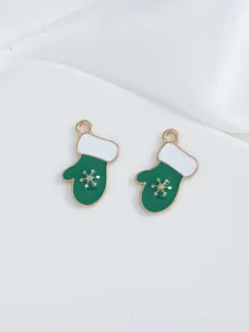 Detail of green enamel Christmas glove pendants with gold snowflake for DIY jewelry making
