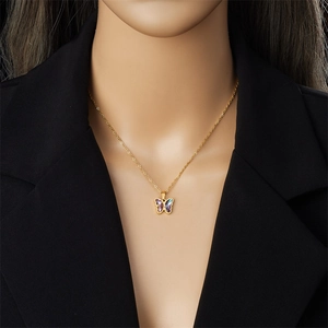 Gold butterfly necklace with gradient blue and purple wings on professional model