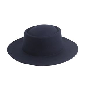 Detailed texture of dark blue wool felt hat with flat top and smooth matte finish