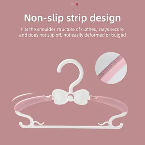 Pink and white retractable kids clothes hangers with non-slip grip and bow detail