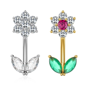 Detailed close-up of floral belly rings with silver zircon and gold colorful crystals