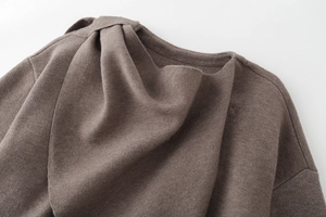 Detail shot of the unique pleated neckline on this brown knit coat showing soft texture