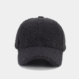 Detailed close-up of black sherpa baseball cap showing premium fuzzy lamb wool texture