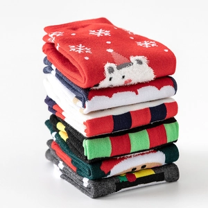 Set of 4 festive cotton Christmas socks featuring colorful cartoon patterns and winter motifs