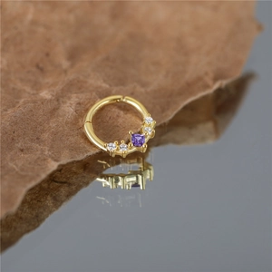 Detailed macro view of S925 sterling silver hoop with purple square stone and white zircons