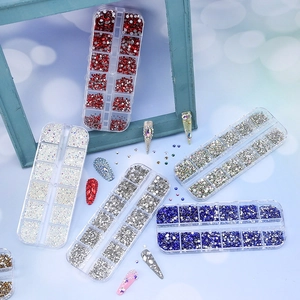 Macro detail of multi-color glass nail rhinestones in a 12-grid organizer box set
