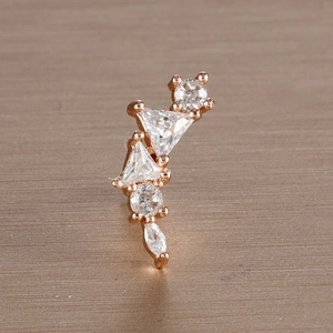 Macro shot of rose gold leaf stud earrings with sparkling white cubic zirconia stones