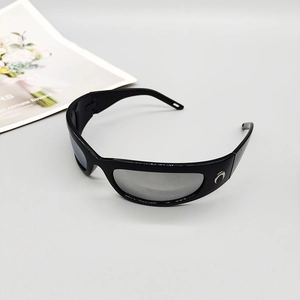 Detail view of sports sunglasses featuring a silver crescent logo on glossy black frames