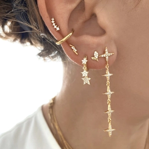 Golden S925 earring set with sparkling star tassels and geometric studs on model