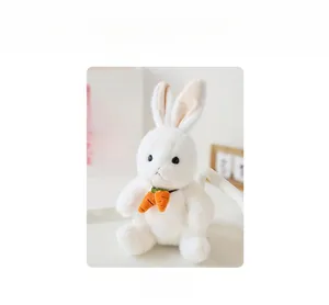 Detailed close-up of soft white plush rabbit toy featuring orange carrot neck accessory