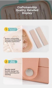 Detail of adjustable dividers and secure metal buckle inside the pink jewelry box