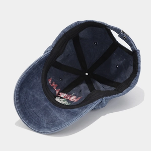Inside view of washed denim baseball cap featuring six-panel stitching and metal buckle