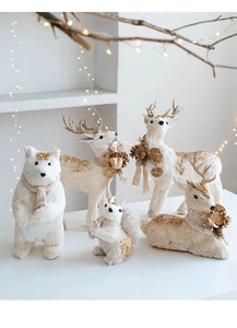 Macro shot of festive cream fur animal set with gold glitter and cozy knit scarves
