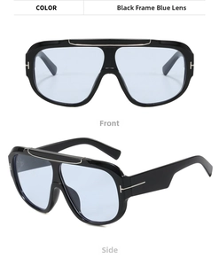 Detail of oversized sunglasses featuring T-shaped metal logo and light blue lenses