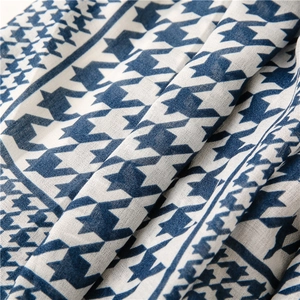 Close-up of blue and white houndstooth fabric showing soft texture and fine weave