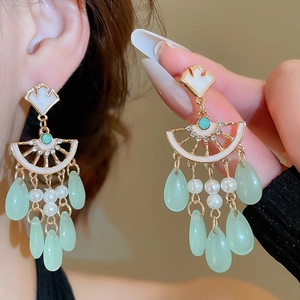 Detail of ginkgo leaf tassel earrings with white pearls and green crystal drops