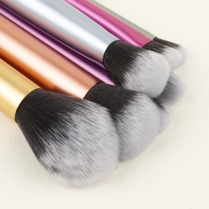 Close-up of dual-tone synthetic bristles and gradient metallic handles on makeup brushes