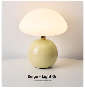 Macro shot of minimalist ceramic mushroom lamp with creamy yellow base and warm soft glow