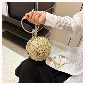 Detail of spherical evening clutch with gold mesh, rhinestones, and circular ring handle