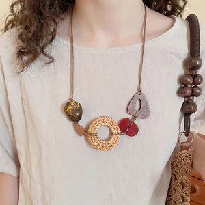 Bohemian rattan and resin geometric pendant necklace with natural wood accents