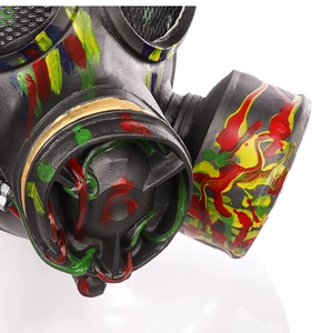 Close-up of steampunk gas mask featuring colorful paint splatters and graffiti details