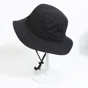 Detail of waterproof black bucket hat featuring wide brim and adjustable chin strap