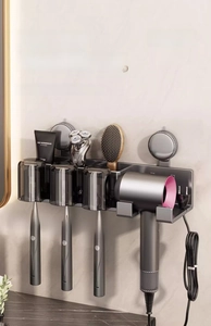 Macro detail of wall-mounted toothbrush holder with hair dryer rack and storage cups