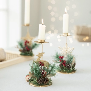 Golden iron Christmas candle holders with pine cones and berries in festive shapes
