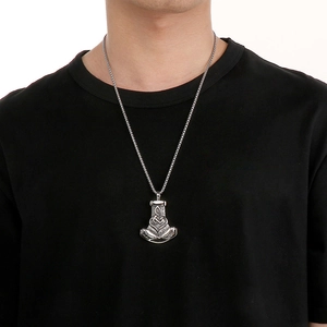 Detailed view of silver Viking Mjolnir pendant with Celtic knots on a braided chain