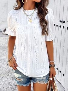 Detail of white hollow embroidery on a casual puff sleeve top for women in summer