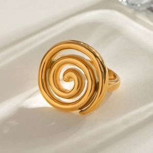 Elegant 18k gold plated stainless steel spiral twisted ring on a textured white surface