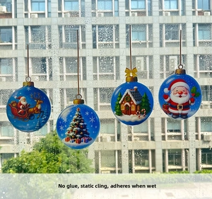 Close-up of static cling Christmas window stickers featuring Santa and gingerbread house