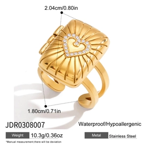 Gold stainless steel ring with rectangular embossed face and crystal heart design