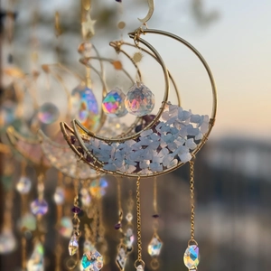 Close-up of golden moon suncatcher with blue and purple crushed crystals in natural light