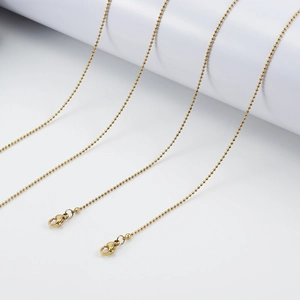 Detail view of 18K gold plated stainless steel bead chains with durable lobster clasps