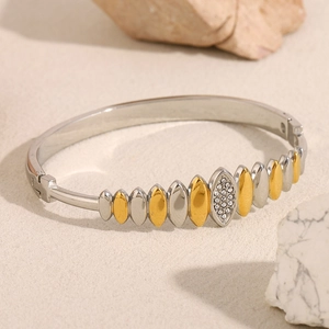 Modern 18K gold and silver plated bangle featuring a teardrop diamond pattern