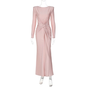 Detail of waist twist knot and pleated texture on a long sleeve evening dress