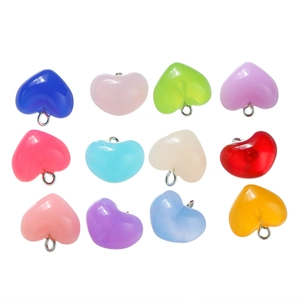 Detail of colorful acrylic heart pendants with silver metal rings for DIY jewelry making