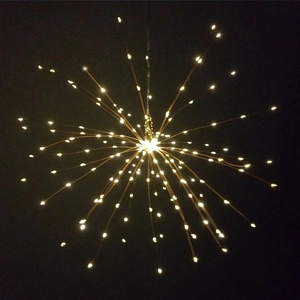 Macro shot of warm white LED firework lights on copper wires against a black background